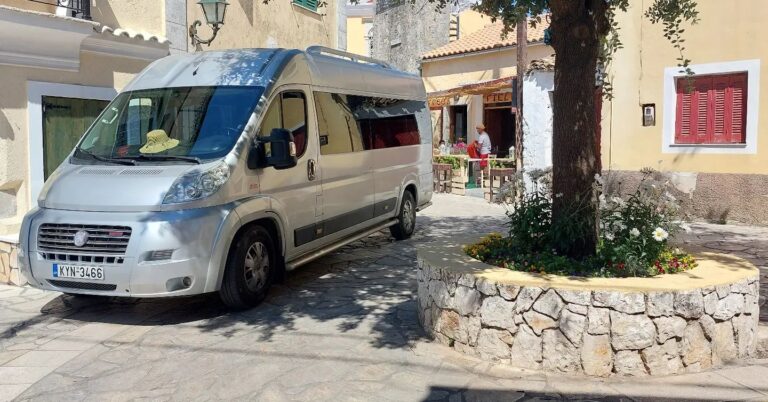 Private transportation van parked in a traditional Corfu village, waiting for passengers.