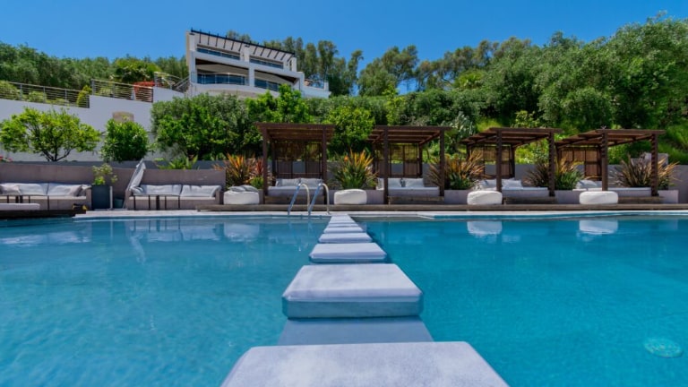 Swimming pool with a luxury hotel in the background